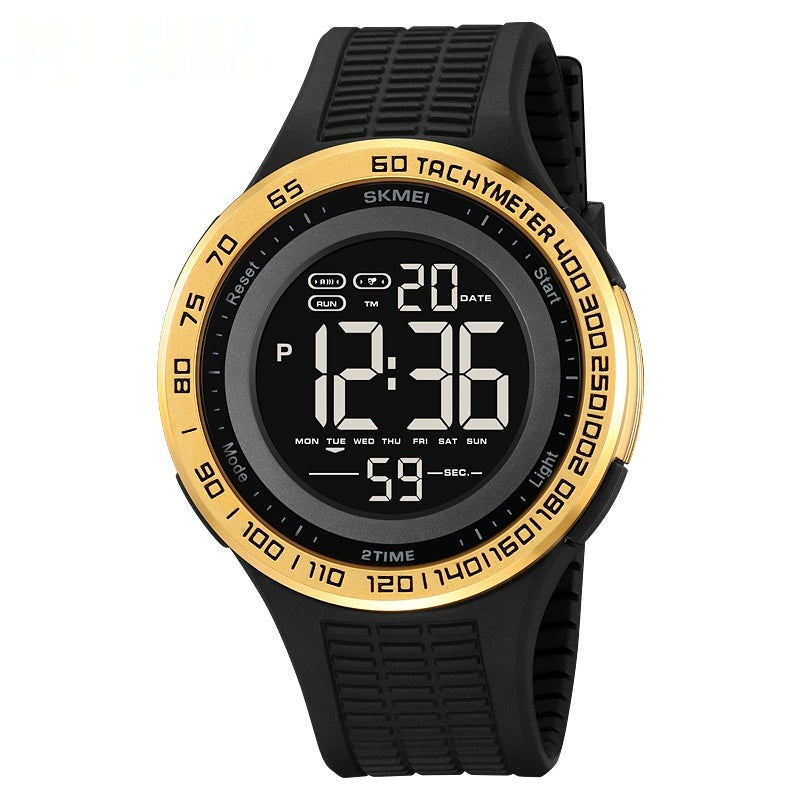 Digital watch with black strap and gold bezel on a white background