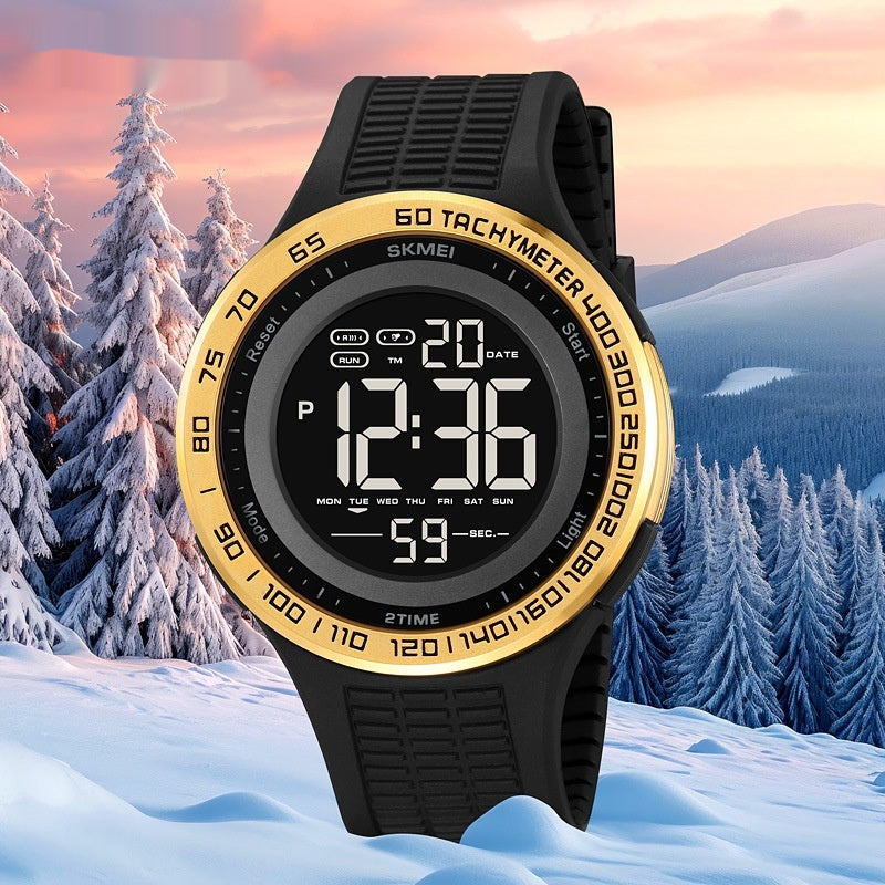 Digital watch with black and gold design on a snowy landscape background