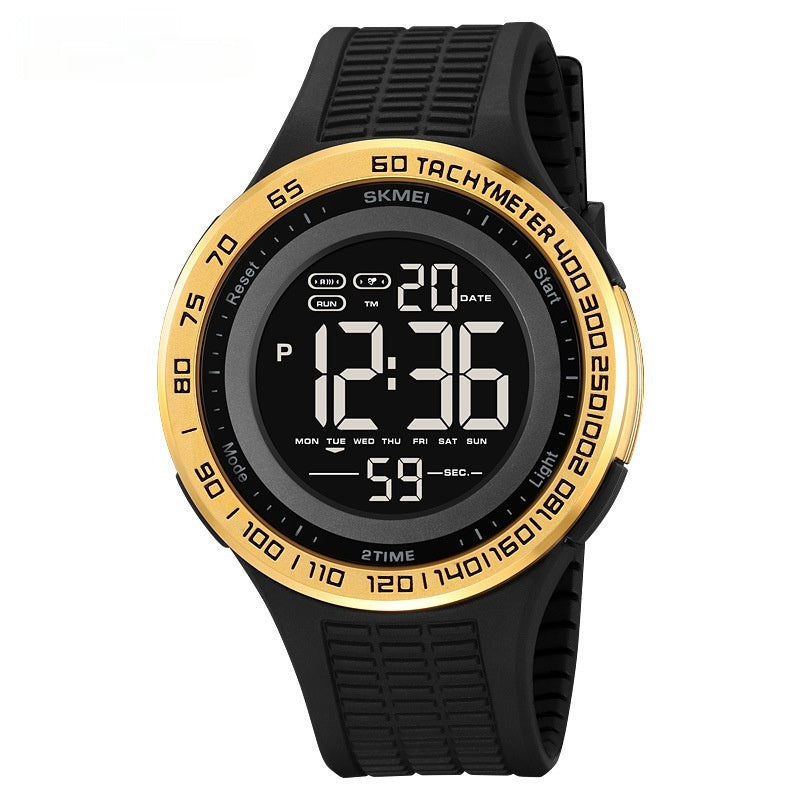 Digital watch with black strap and gold bezel on a white background